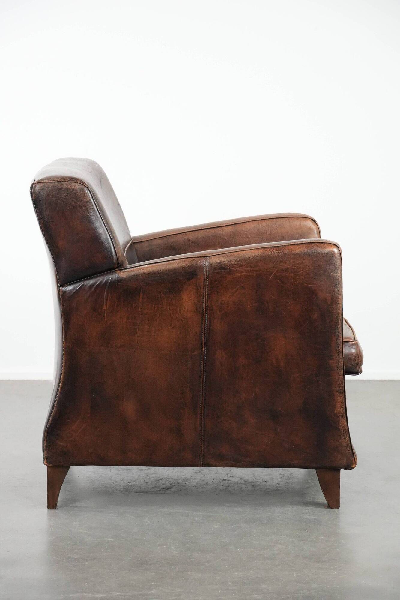 Sleekly shaped timeless design armchair made of sheepskin leather