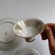 Solitaire tea cup, saucer, and dessert plate in white and gold.