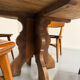 Round table in solid wood, thick top, vintage brutalist style from the 1960s.