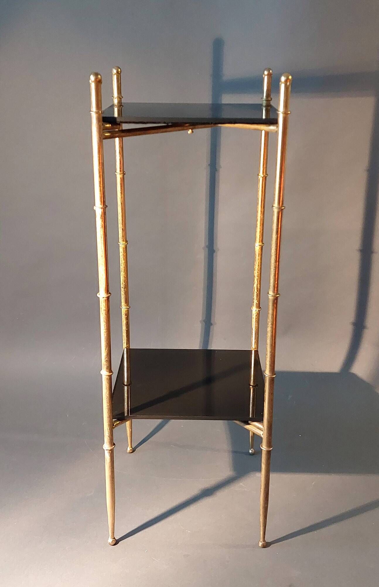 Pedestal table in patinated gilded brass faux foldable bamboo.