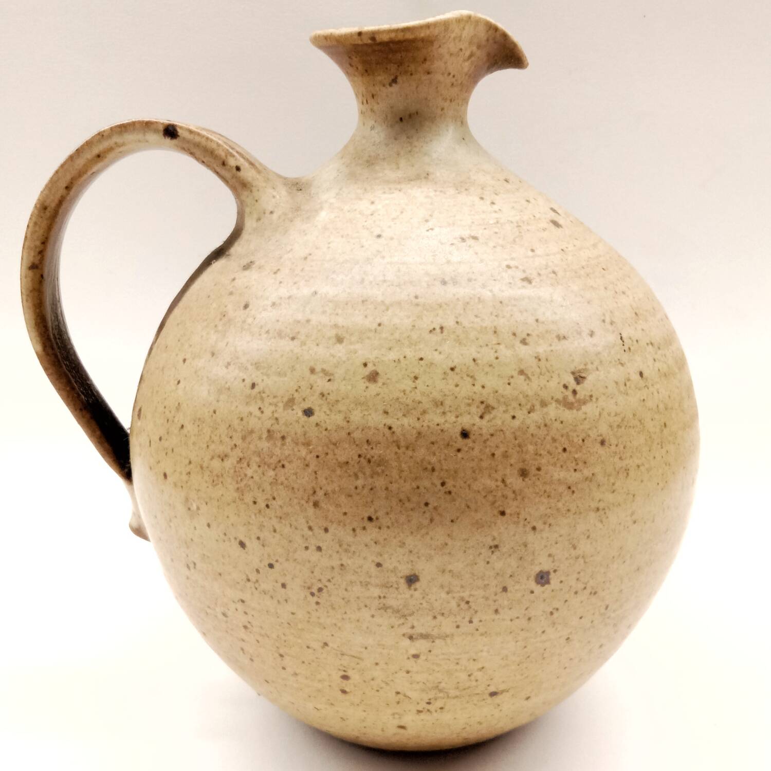 Vintage speckled brown stoneware jug in a round shape.