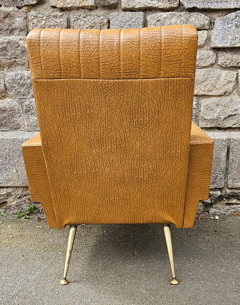 Pair of mustard skaï armchairs, brass feet