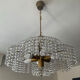 Vintage lucite chandelier with a cascade of crystal pendants from the 1970s.