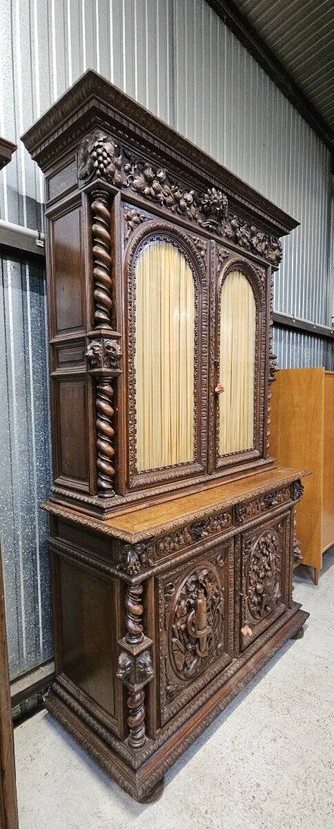 Two-body buffet in solid oak, richly carved in the Renaissance style.