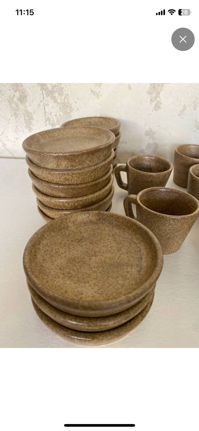 Set of stoneware coffee cups with saucers.