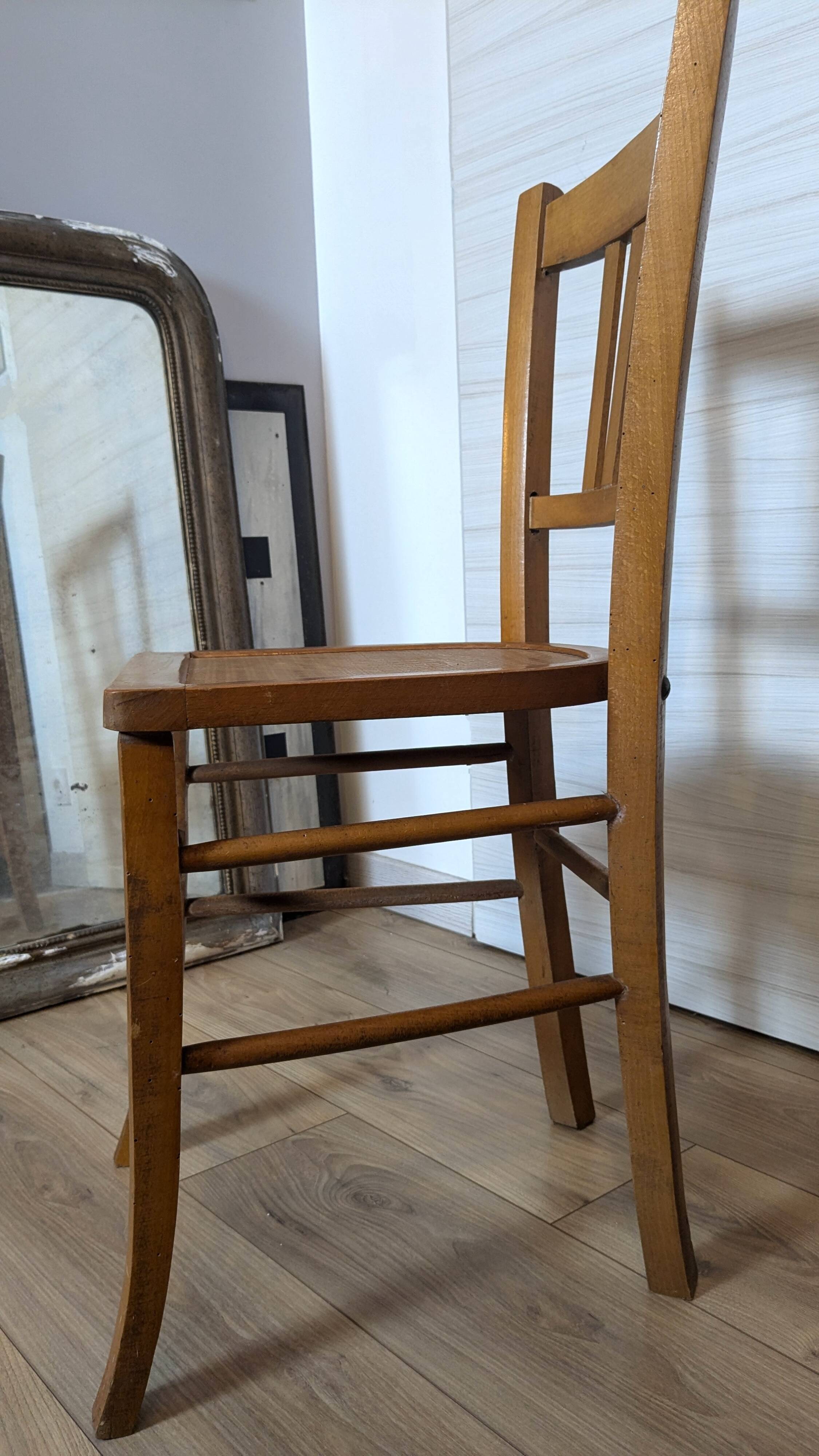Antique patinated wooden bistro chair from the early 20th century.