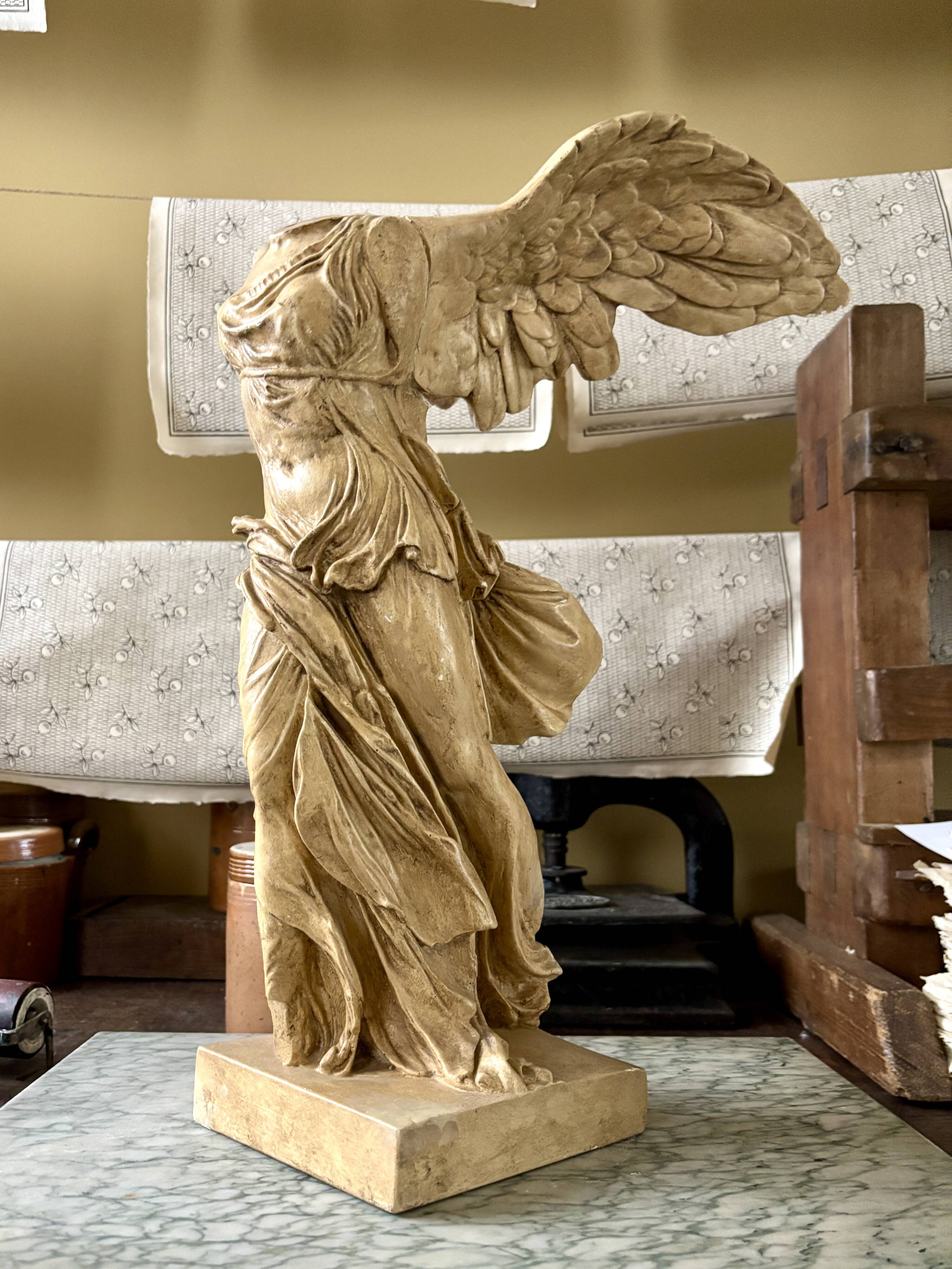 "Winged Victory of Samothrace", beige plaster statuette