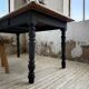 Oak farmhouse table with turned black legs.
