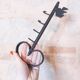 Old wall key holder in the shape of a vintage metal key 4 hooks