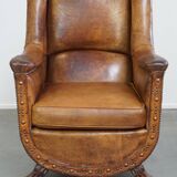 Characteristic antique sheepskin leather armchair with beautiful details and a unique design