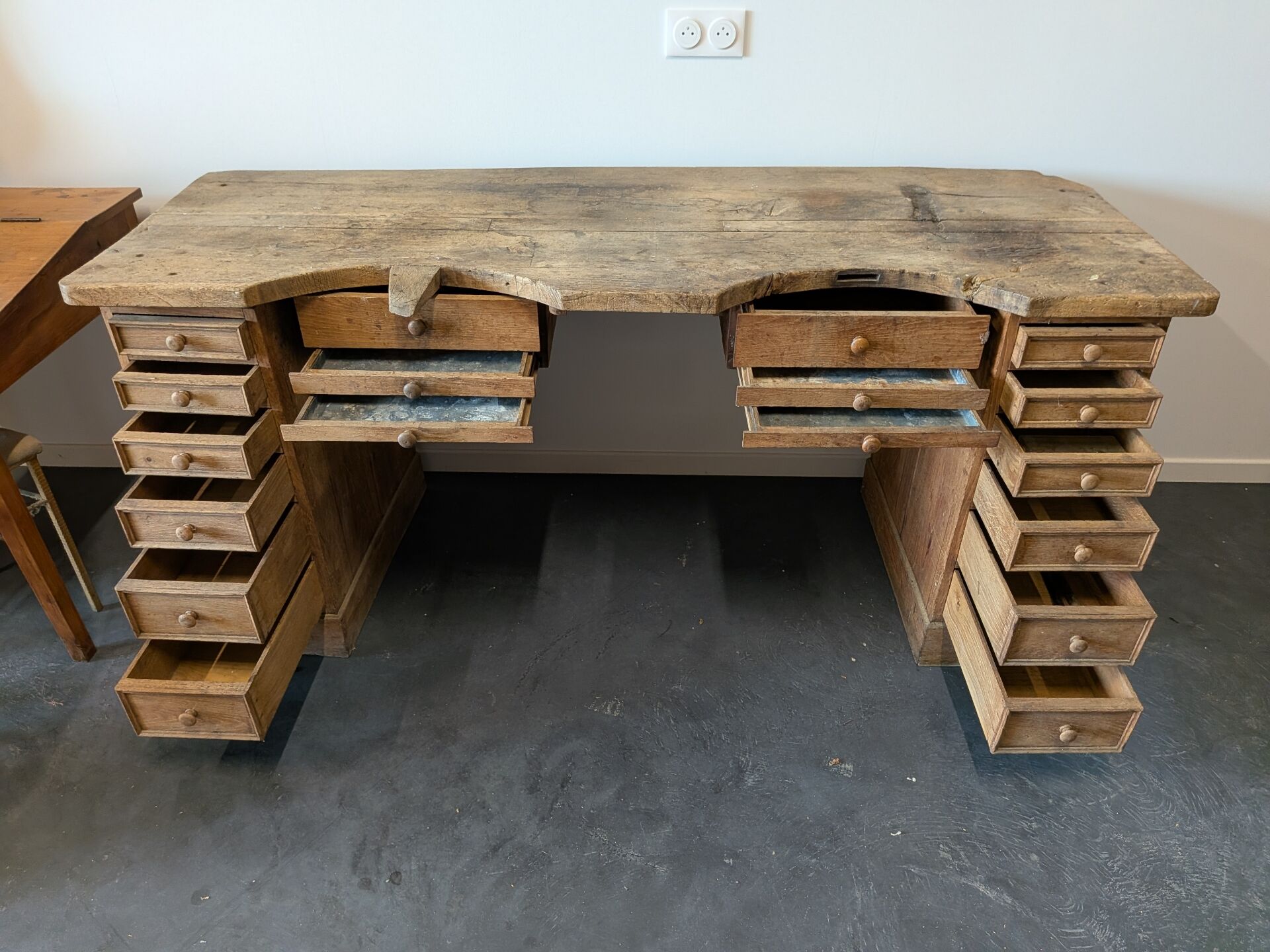 Double jeweller's workbench in solid oak, 18 drawers, early 20th century.