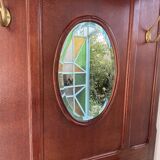 Antique wooden coat rack with mirror and shelf.
