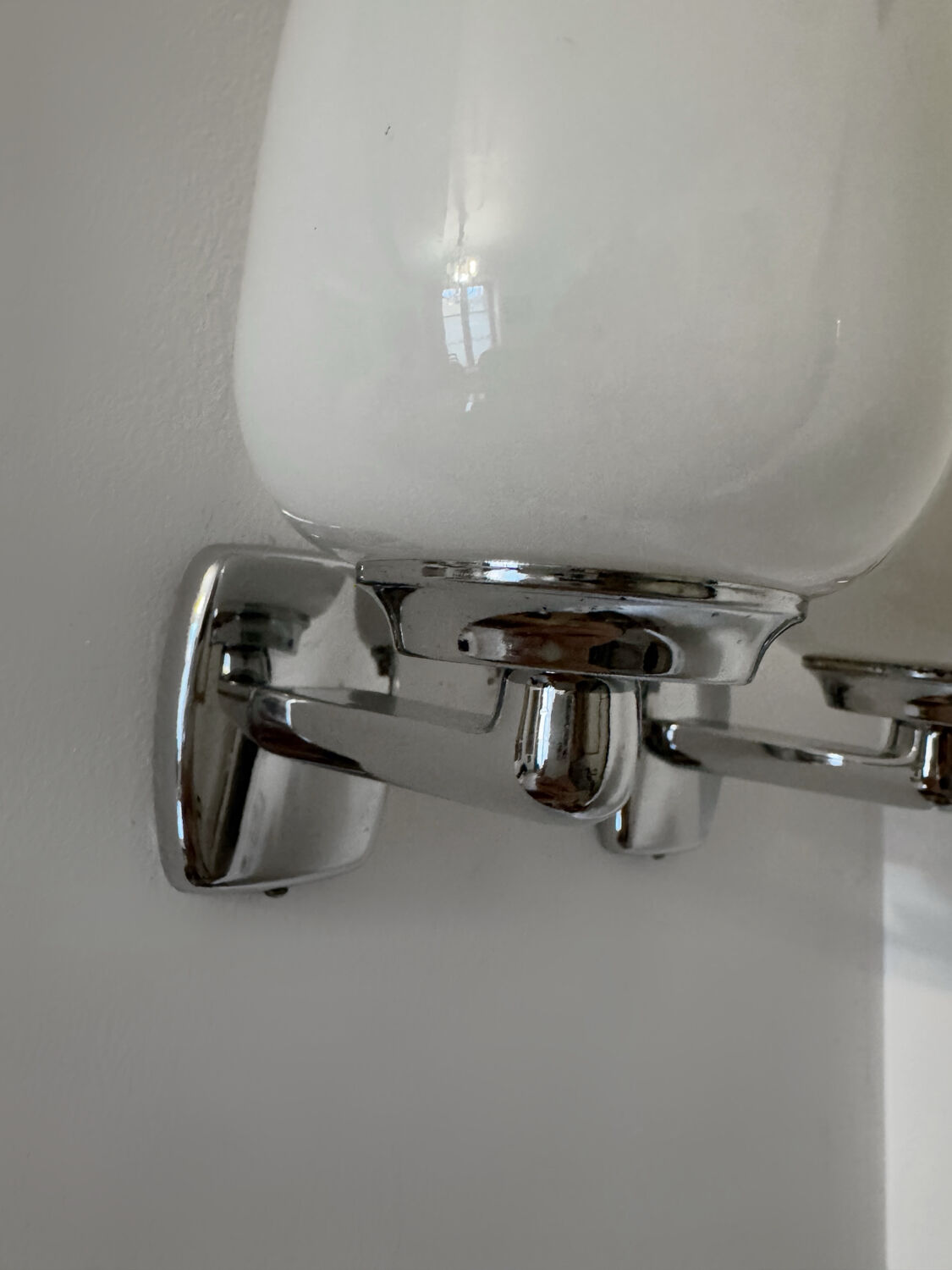 Chrome and opaline wall lights from the 70s.