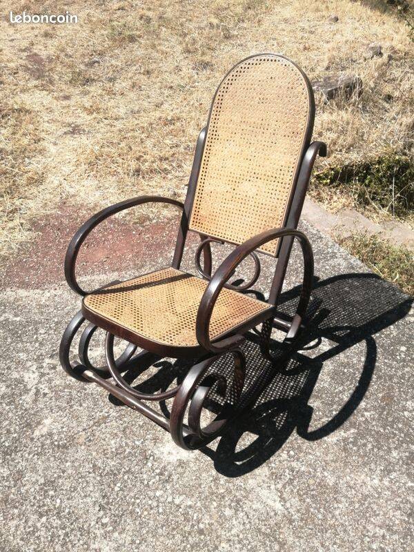 Vintage Thonet rocking chair in cane and bent wood.