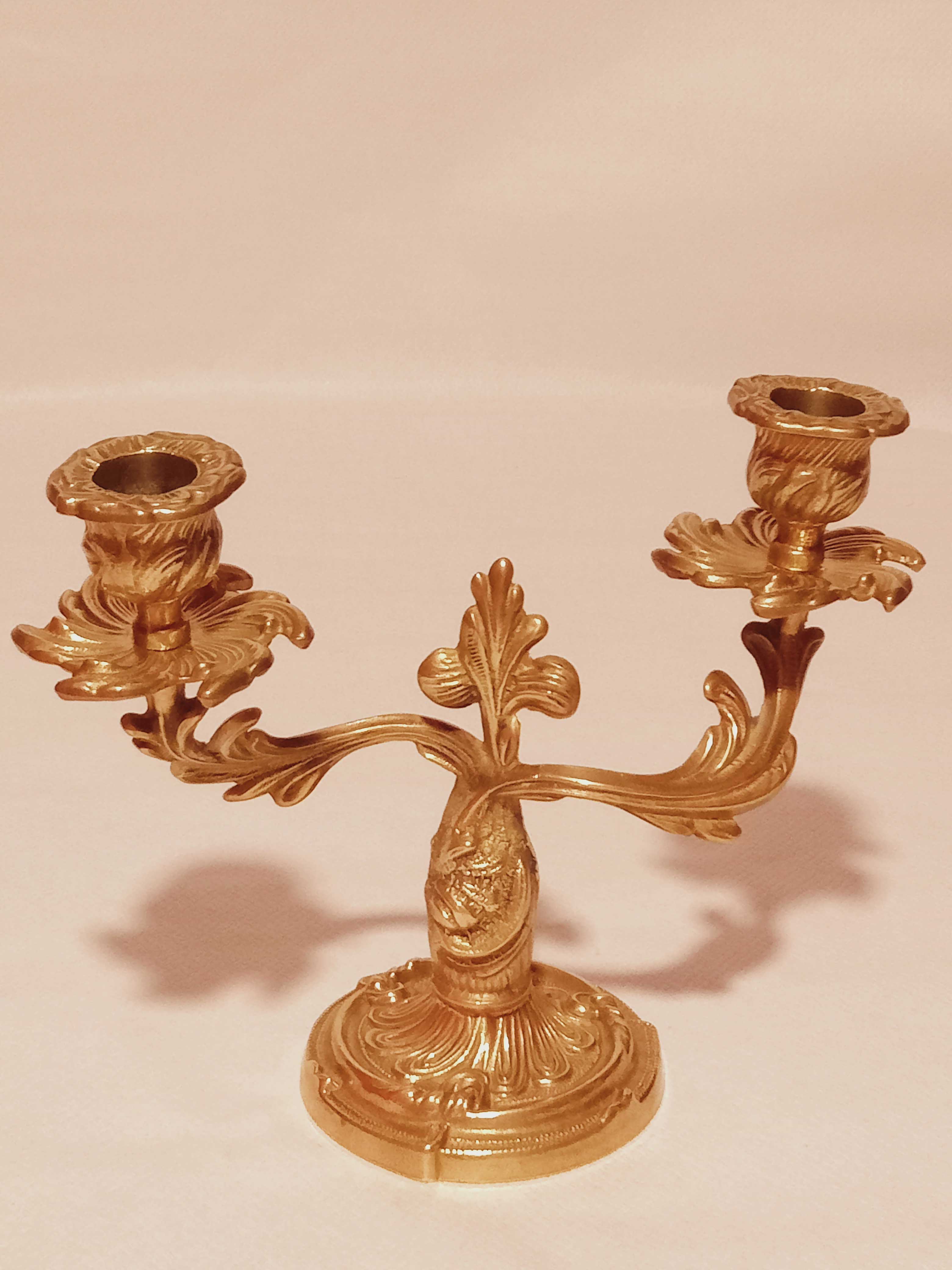 Old candle holder in gilded bronze