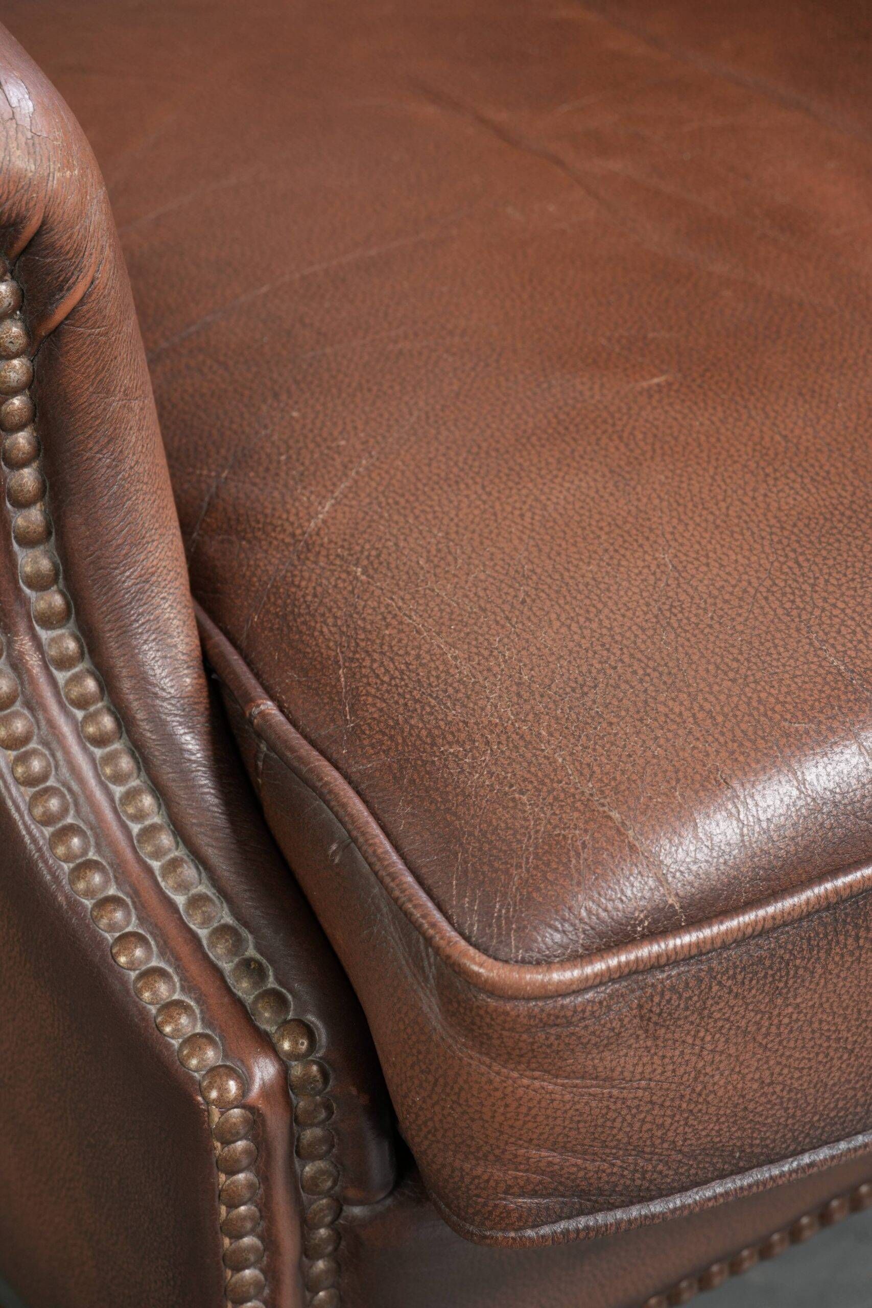 Comfortable cowhide wingback armchair in English style with a timeless look