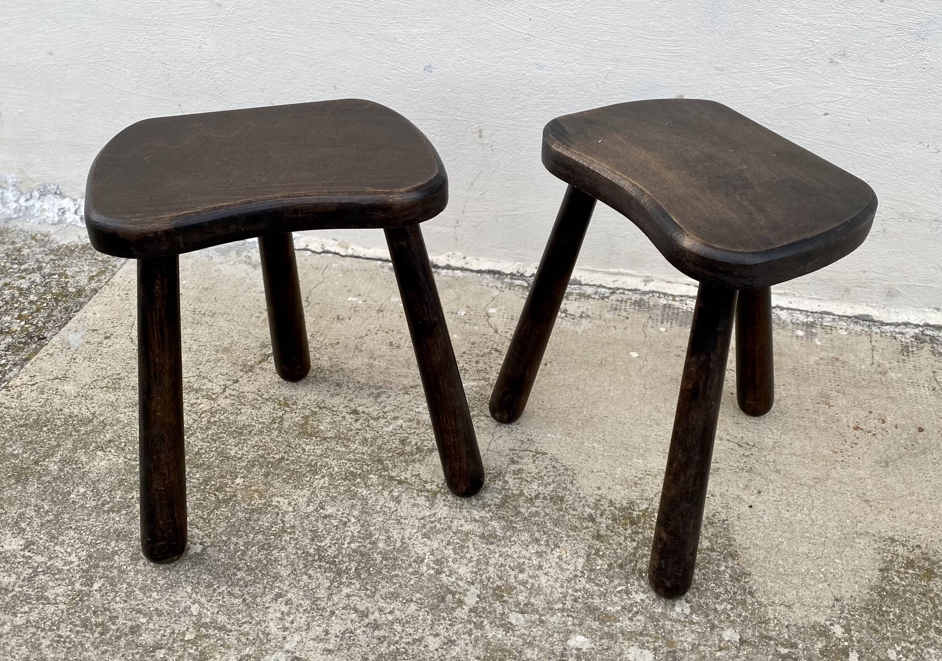 Pair of vintage stained wood tripod stools from the 1970s