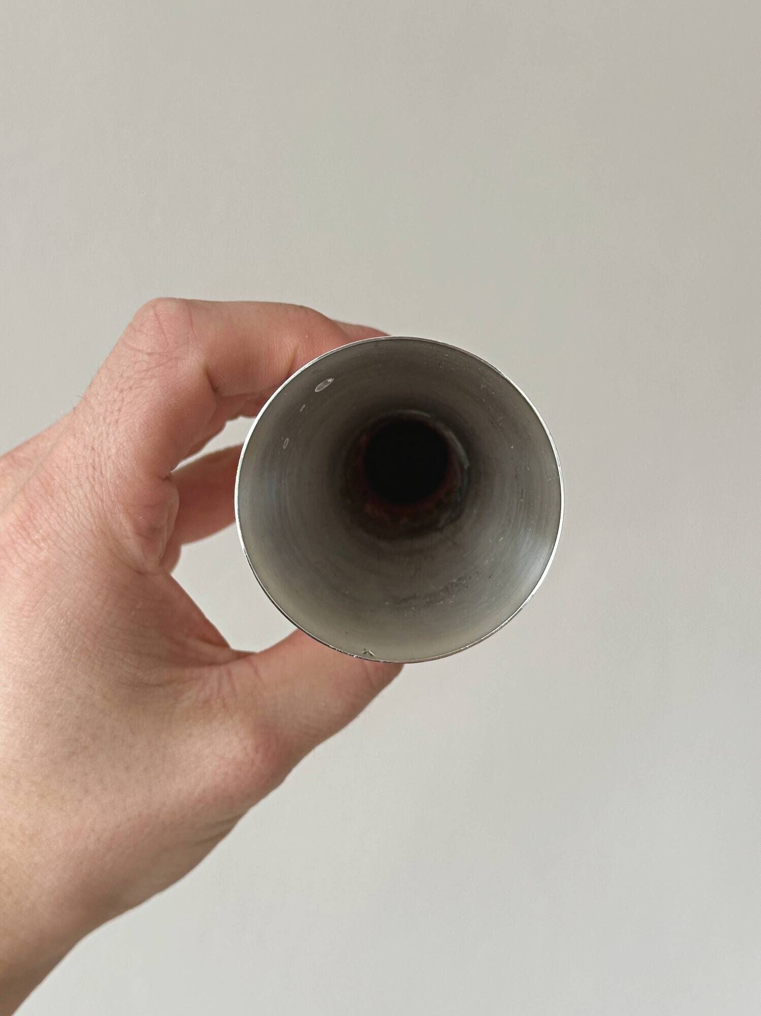 Two silver-coloured lightweight metal flower vases.