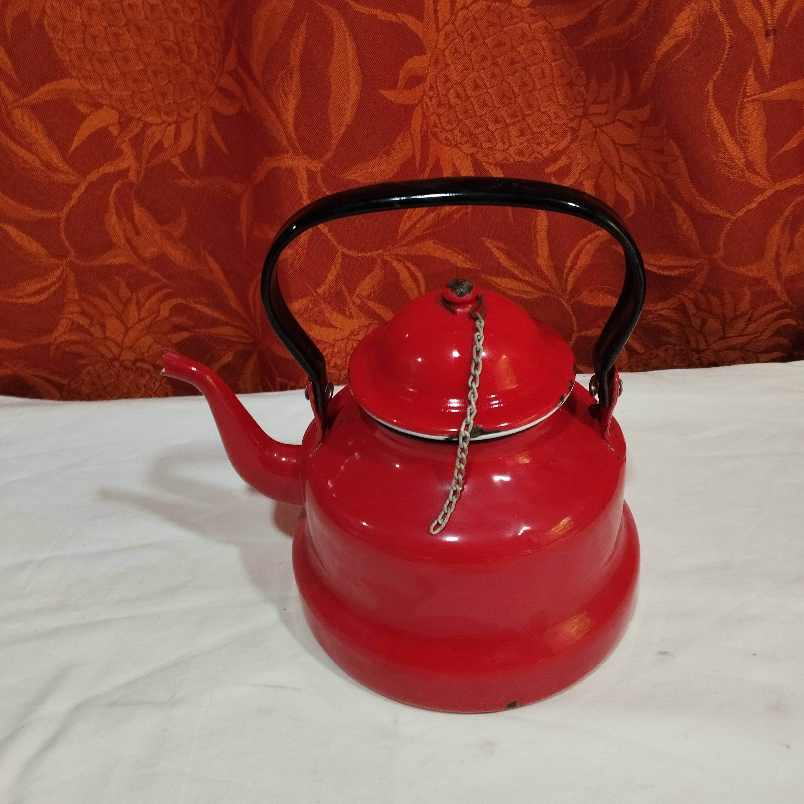 red enamelled sheet metal kettle