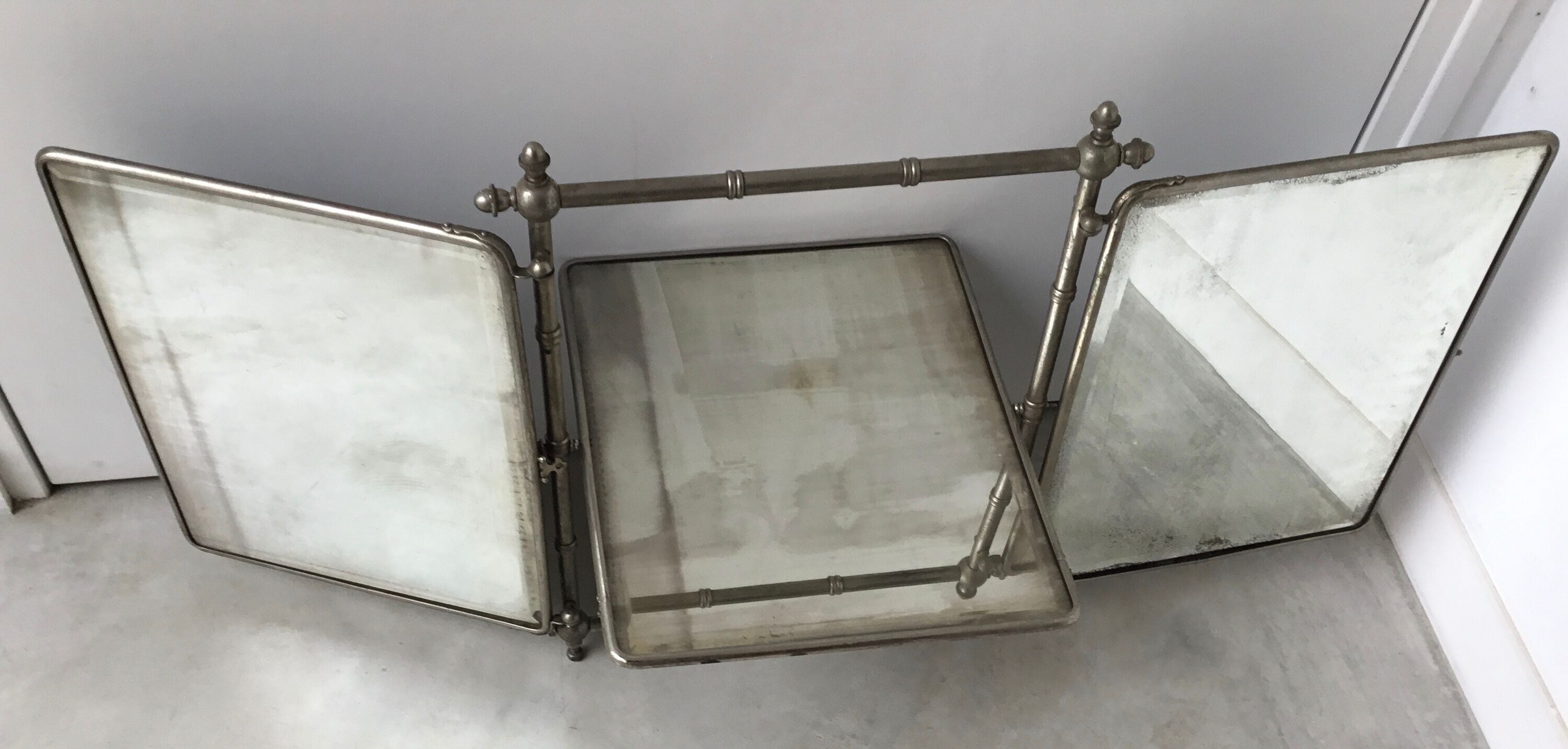 Large and old mirror of tryptic barbier