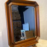 Beveled mirror in its wooden frame