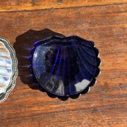 Vintage silver-plated shell butter dish with blue bowl.