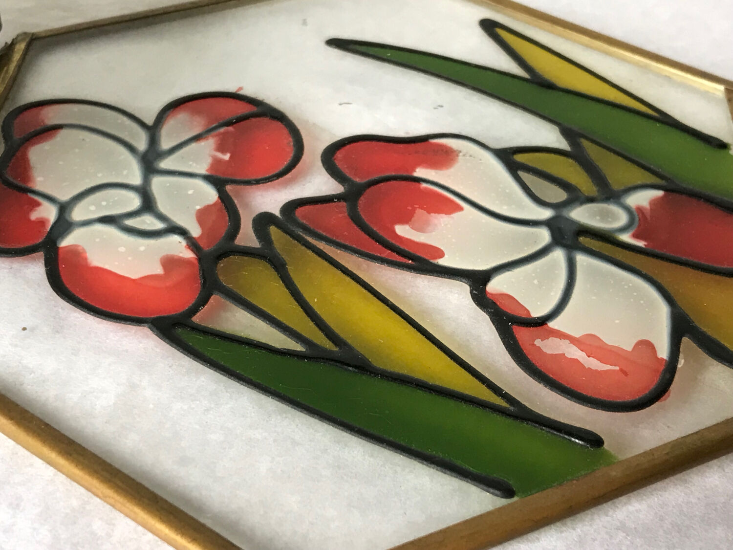 Glass box and hexagonal brass enamelled floral decoration