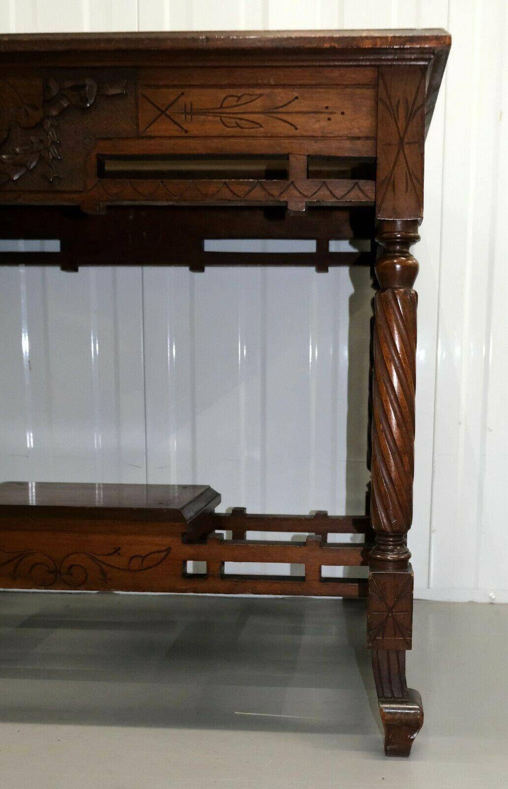 19th-century carved walnut desk with a leather top.