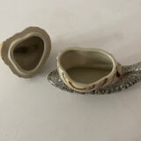 Porcelain figurine snail and its small