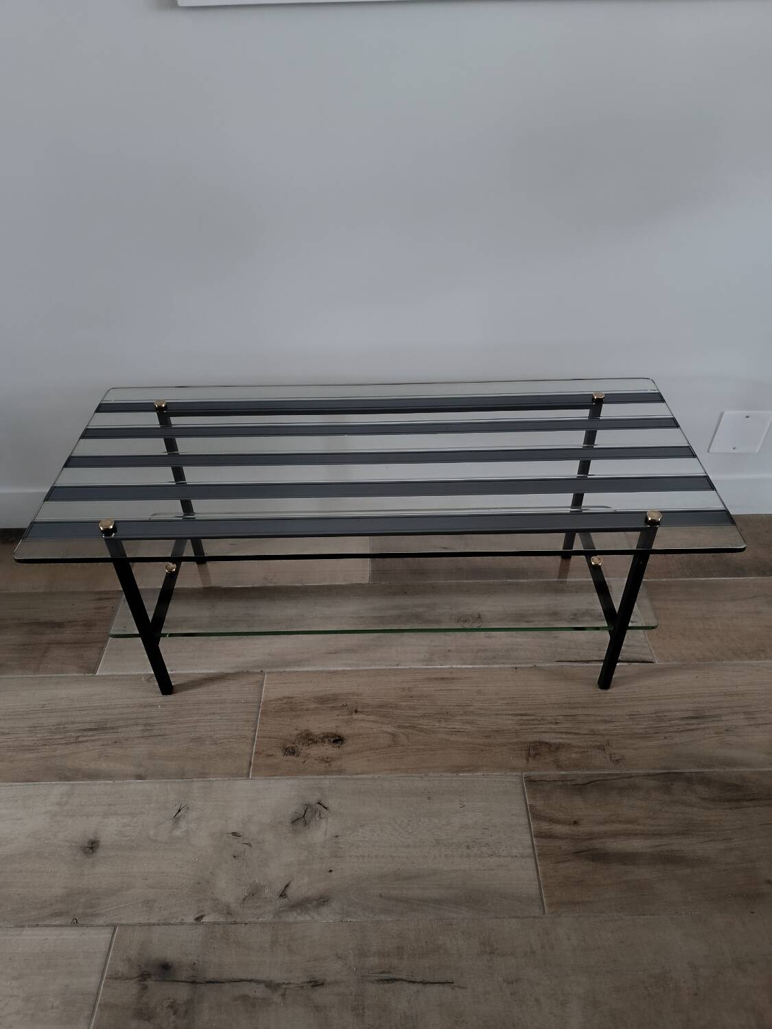 Vintage coffee table in glass and mirror strips.