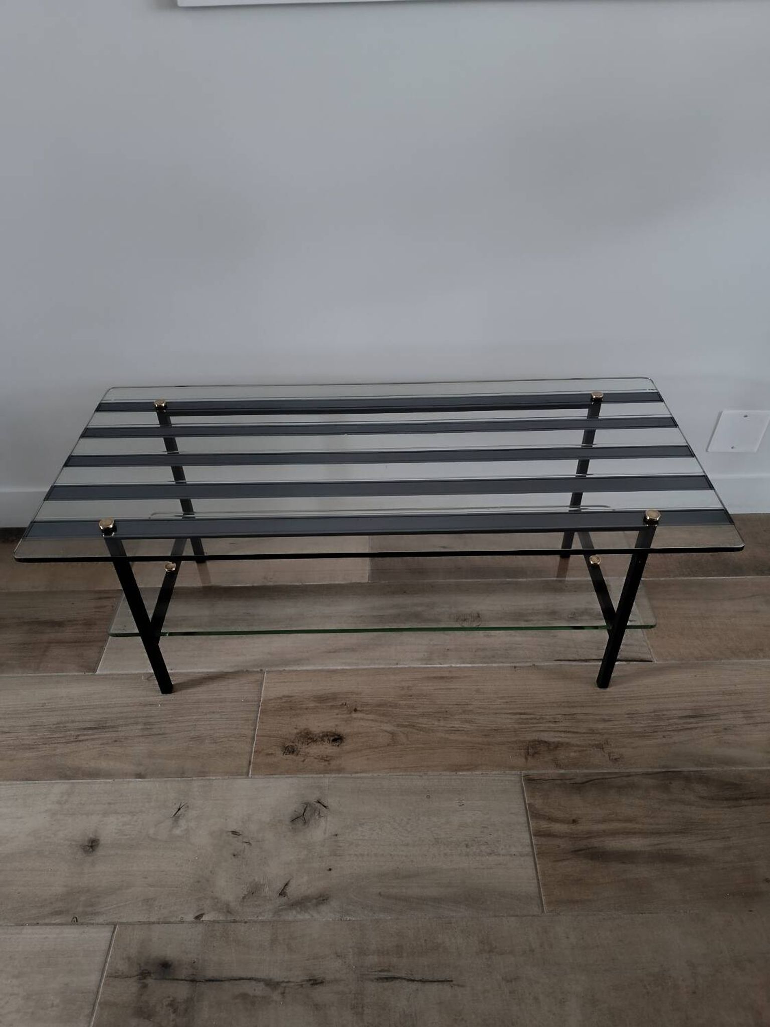 Vintage coffee table in glass and mirror strips.