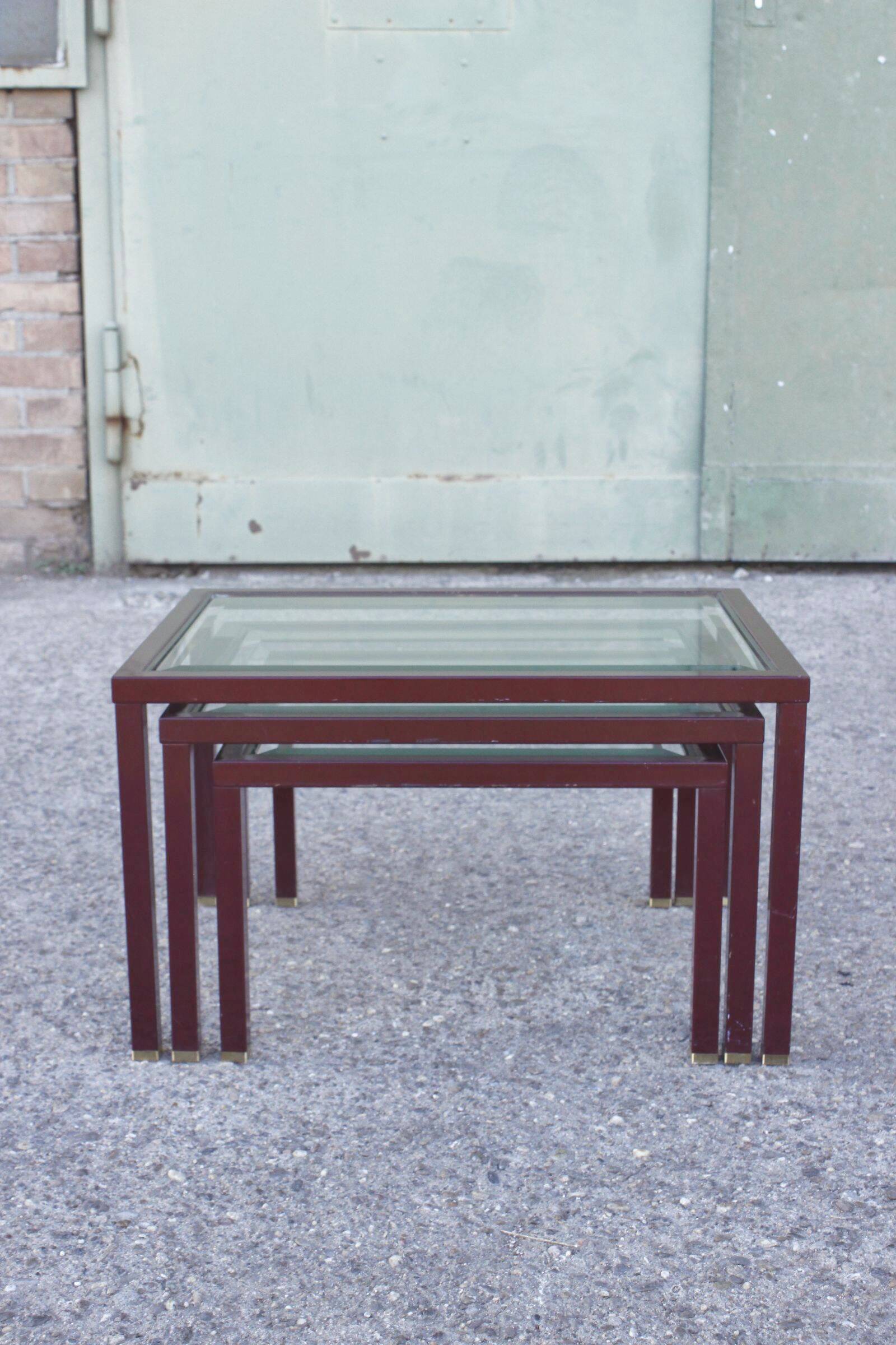 Nesting tables in burgundy lacquered metal and brass, France 1950s