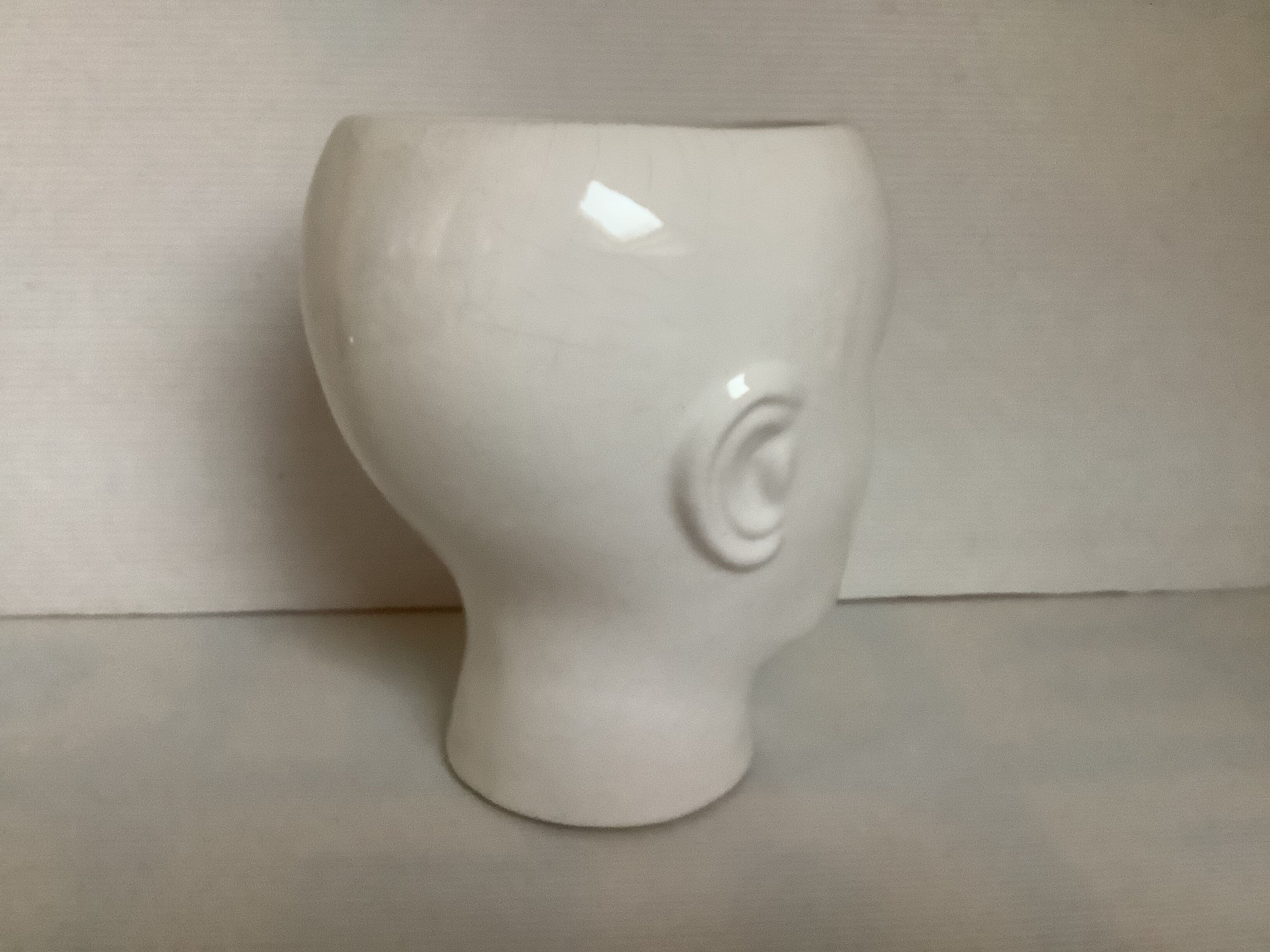 Man's head hide pot vase
