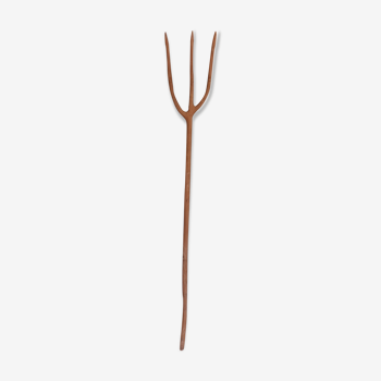 Old artisanal fork in monoxyl wood of hackberry