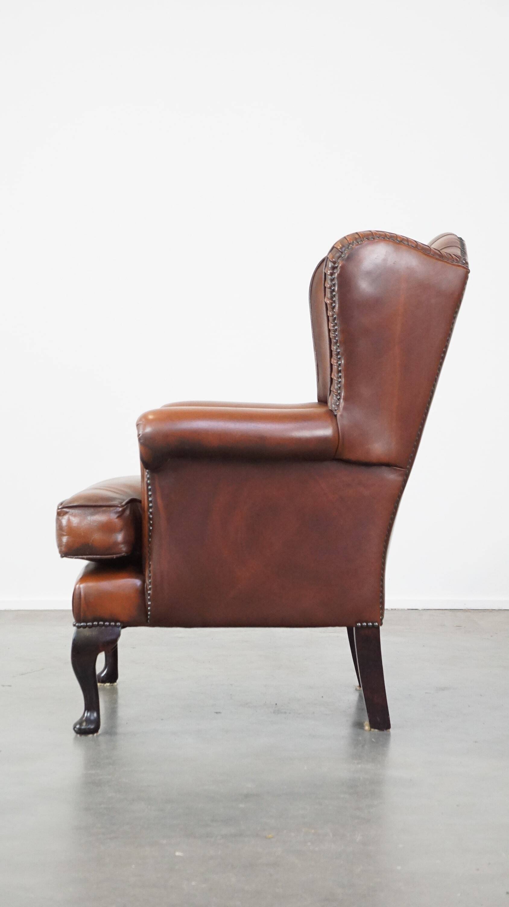 Brown leather wingback Chesterfield armchair