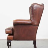 Very beautiful, stately, cowhide Chesterfield wing chair with elegant legs in a nice brown color