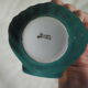 Porcelain pocket tray in the shape of a golden scallop shell with duck green background from the 50s/60s