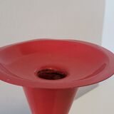 Vintage design candlestick in red metal in the shape of an hourglass
