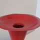 Vintage design candlestick in red metal in the shape of an hourglass