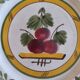 Two earthenware plates with fruits, pears and plums.