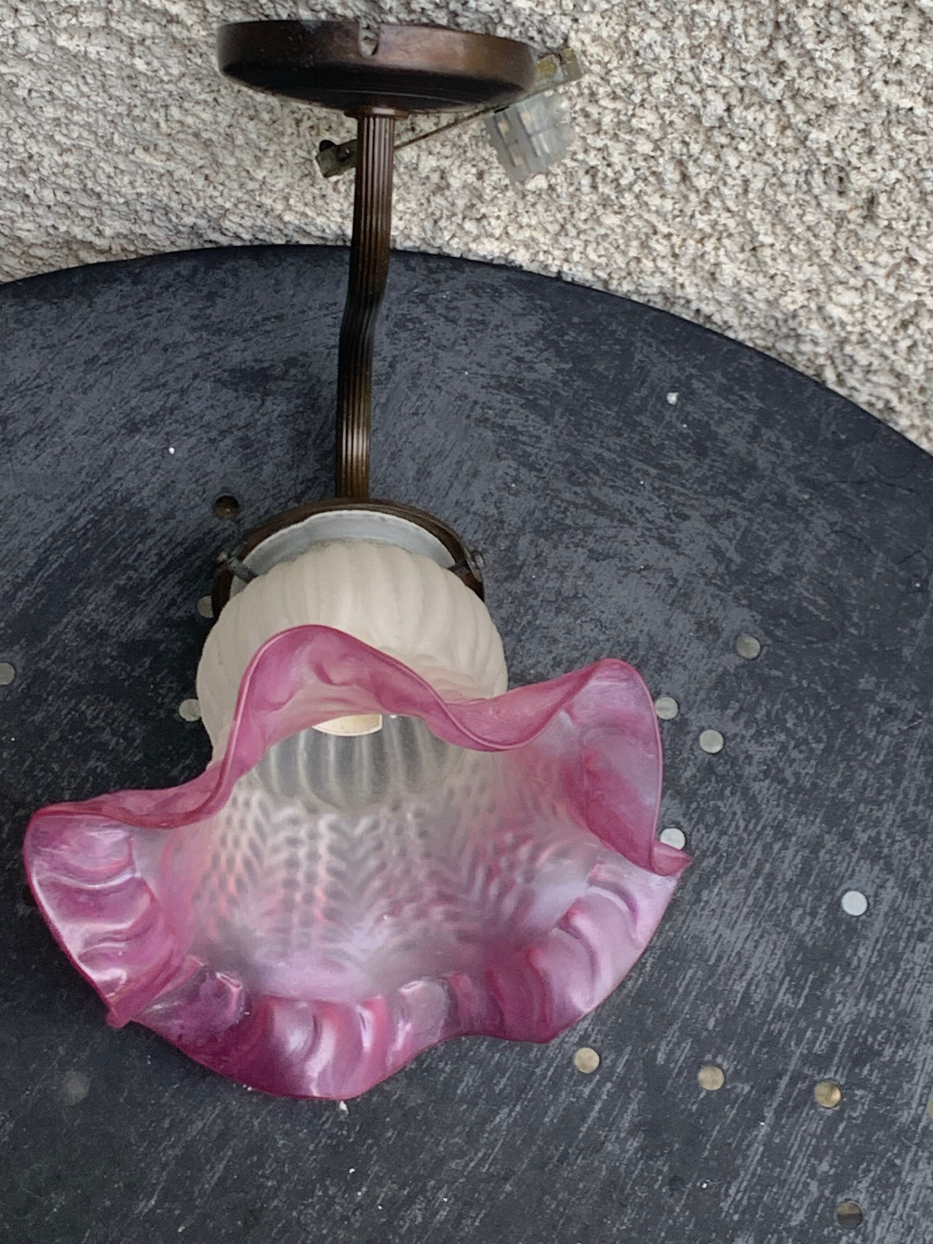 Metal wall lamp with frosted glass shade in the shape of a pink corolla
