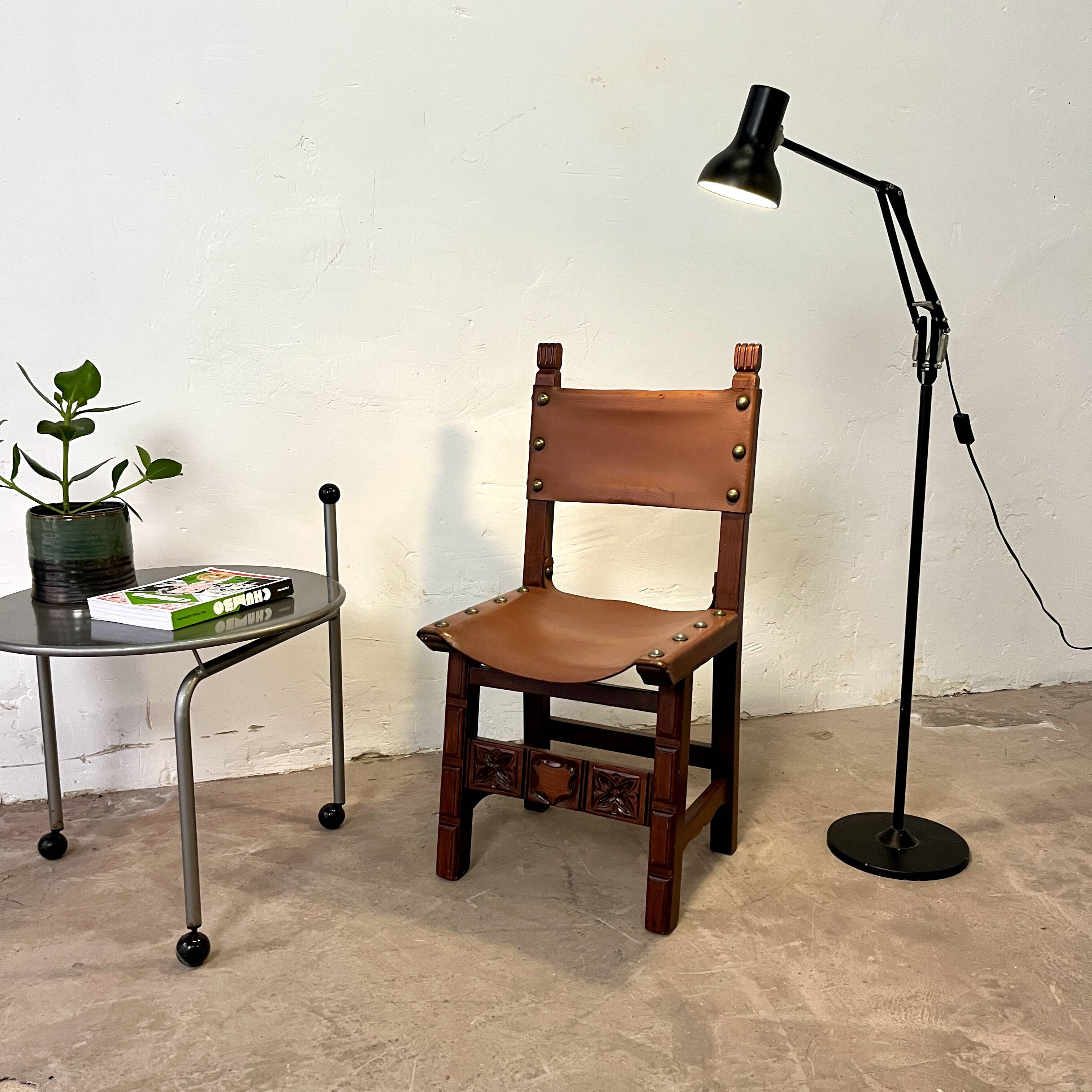 Spanish chair in leather and carved wood, 1950s/60s.