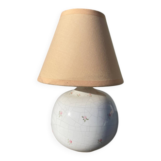 Small cracked white ceramic lamp with flowers.
