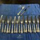 Set of 12 knives and 12 forks by Mappin and Webb in silver-plated metal.