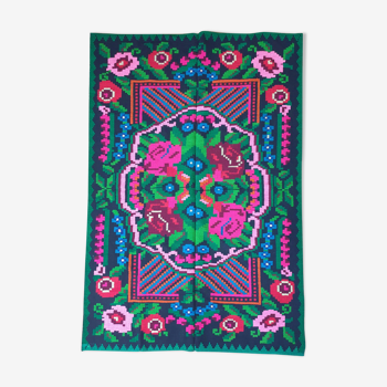 Handwoven colorful Romanian carpet, green and black background with gorgeous colorful flowers