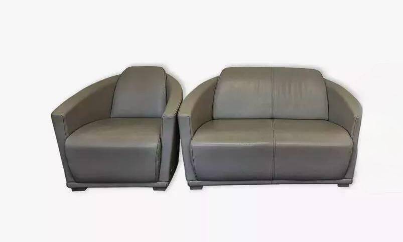 Two-seater sofa and a grey leather armchair Italia.