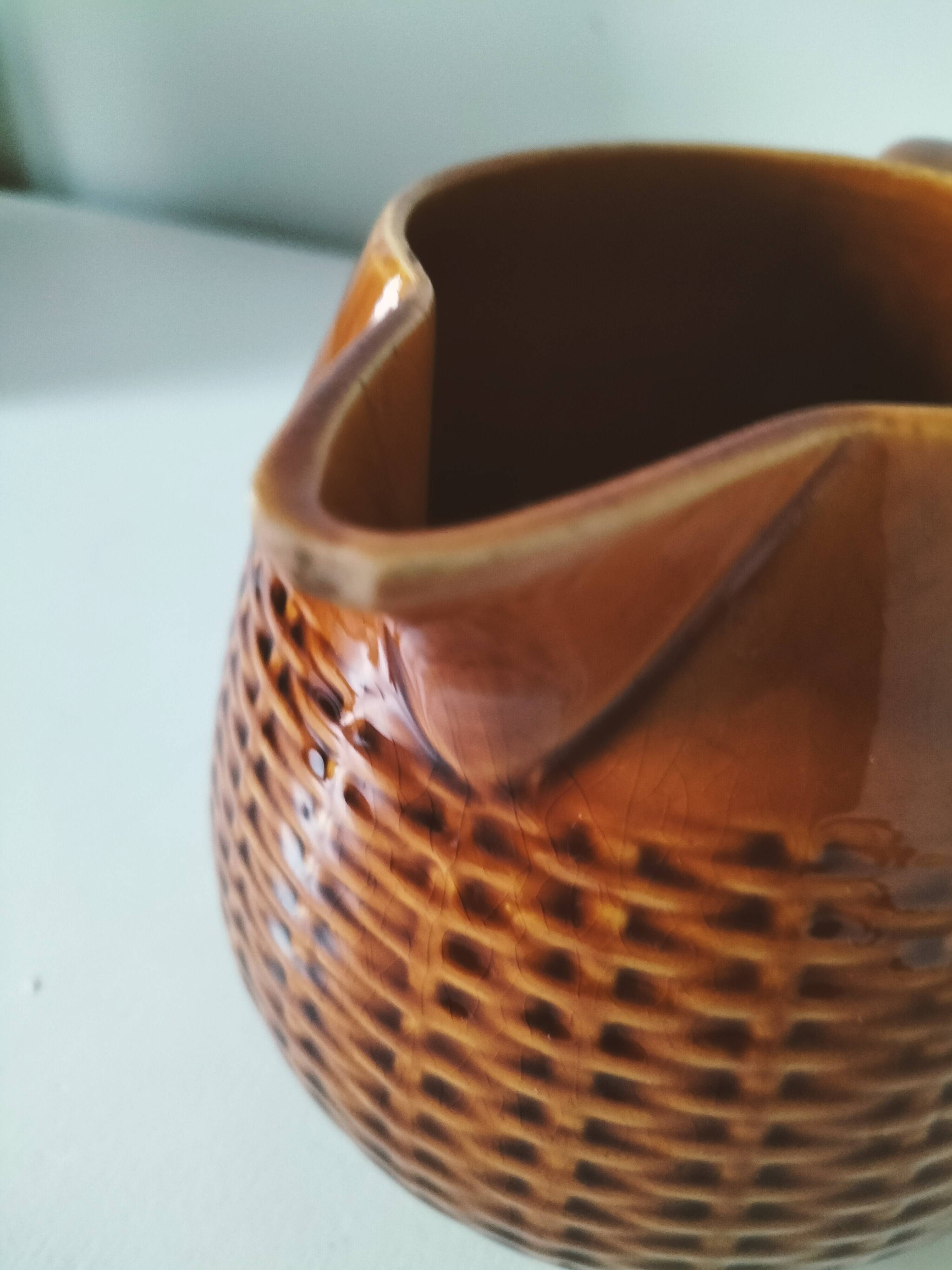 Caramel slipware pitcher with braided relief