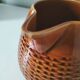Caramel slipware pitcher with braided relief