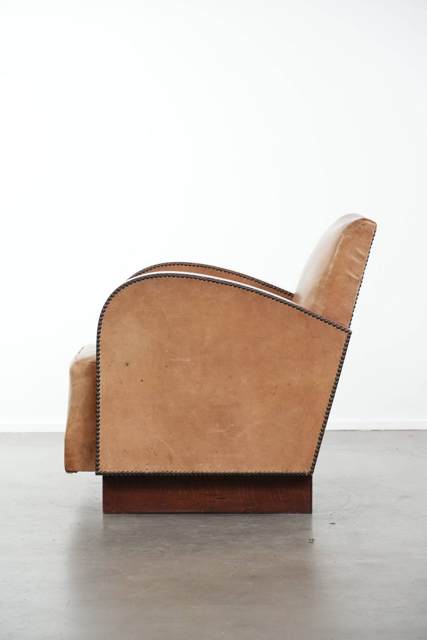 Art Deco design armchair in light cognac cowhide leather.