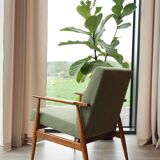 Vintage armchair in swamp green bouclé design by H. Lis.